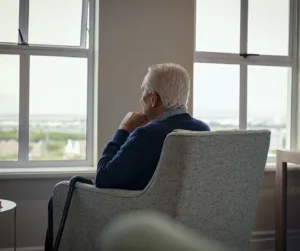 elder sitting close to window